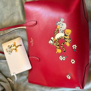kate spade red tote with floral Tigger motif and cream wristlet